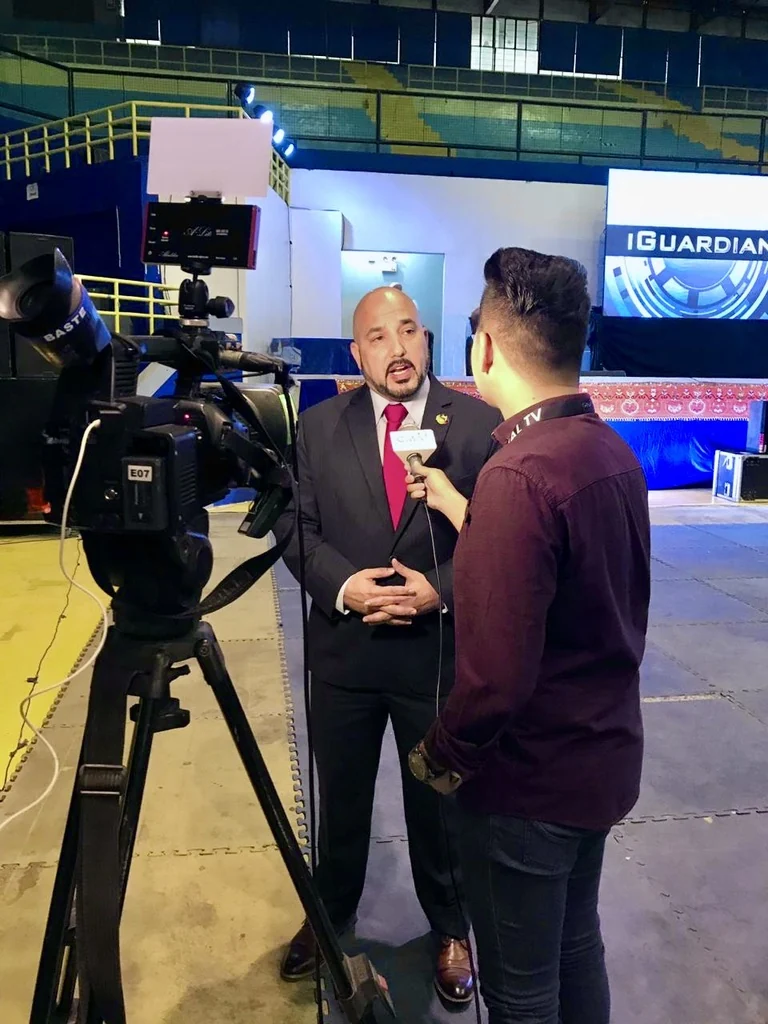 Ricardo Navalta being interviewed on camera at an event