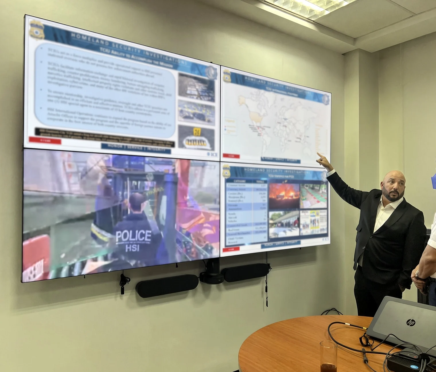 Ricardo presenting a briefing at a multi-screen operations center