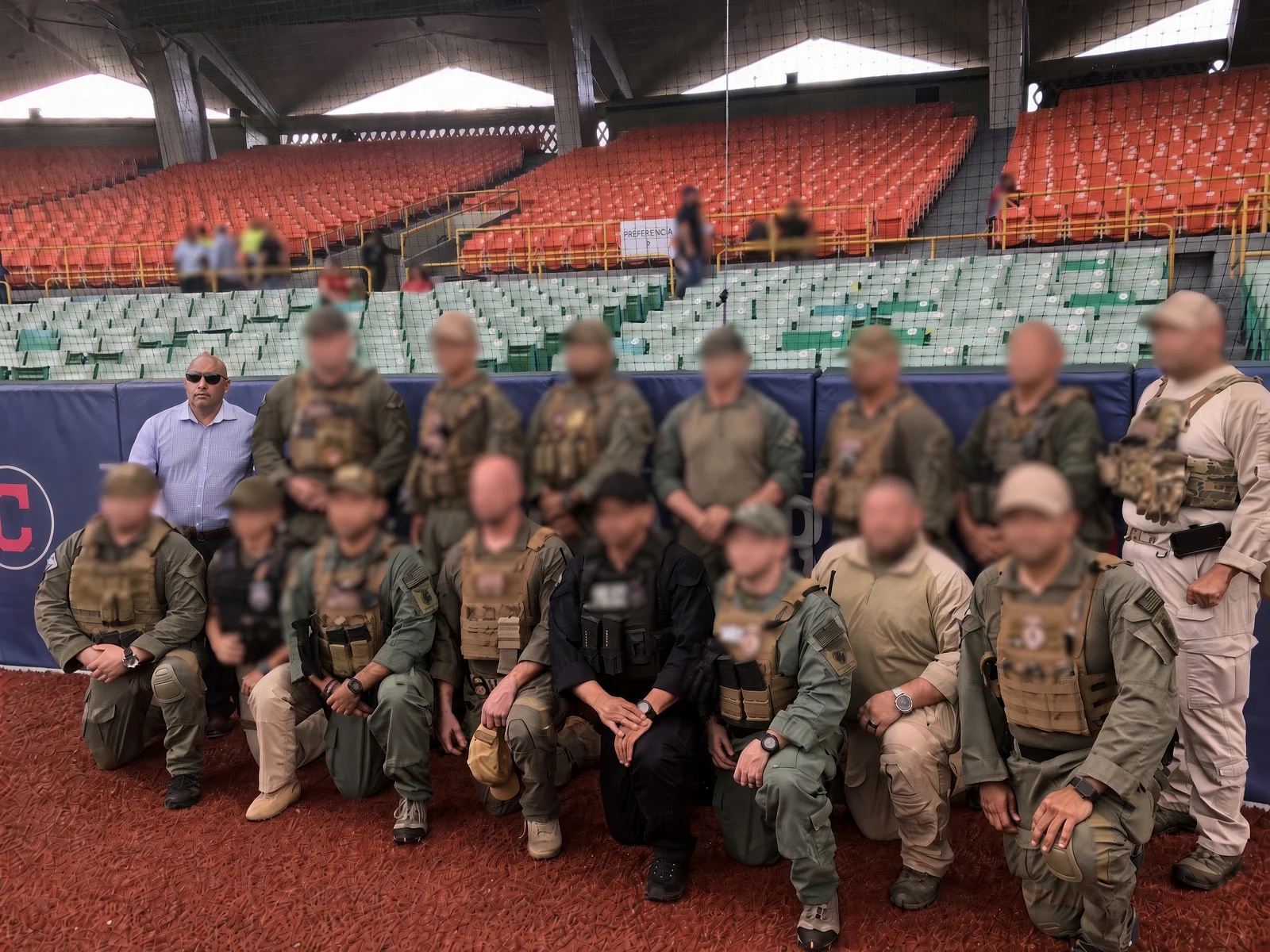 Ricardo Navalta with a group at a stadium, with other faces blurred