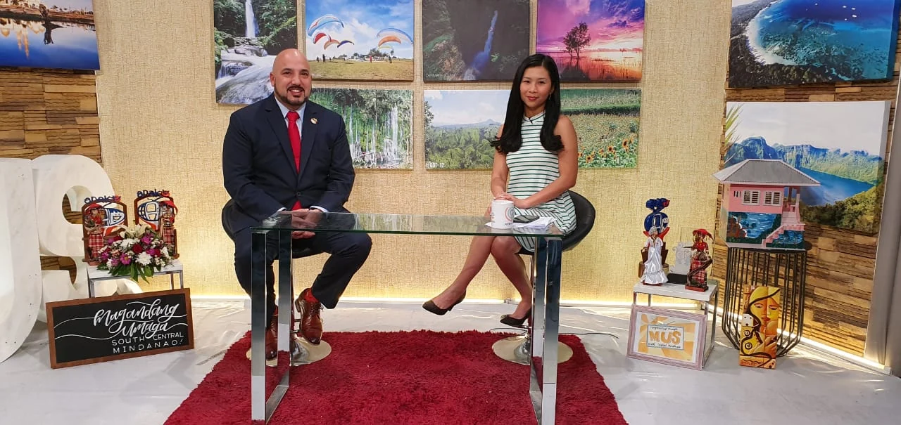 Ricardo Navalta seated with an interviewer in a television studio